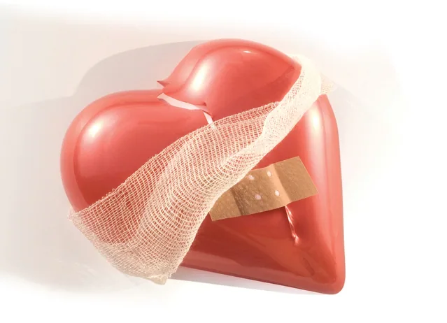 Rotes Herzmodell mit einer weißen Bandage